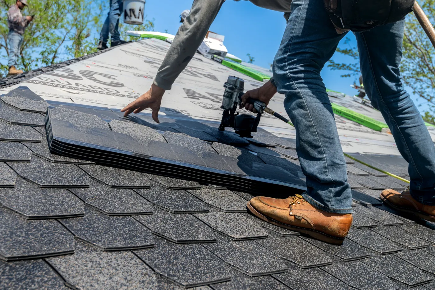 Roofer inspecting tiles on a Florida tile roof at golden hour